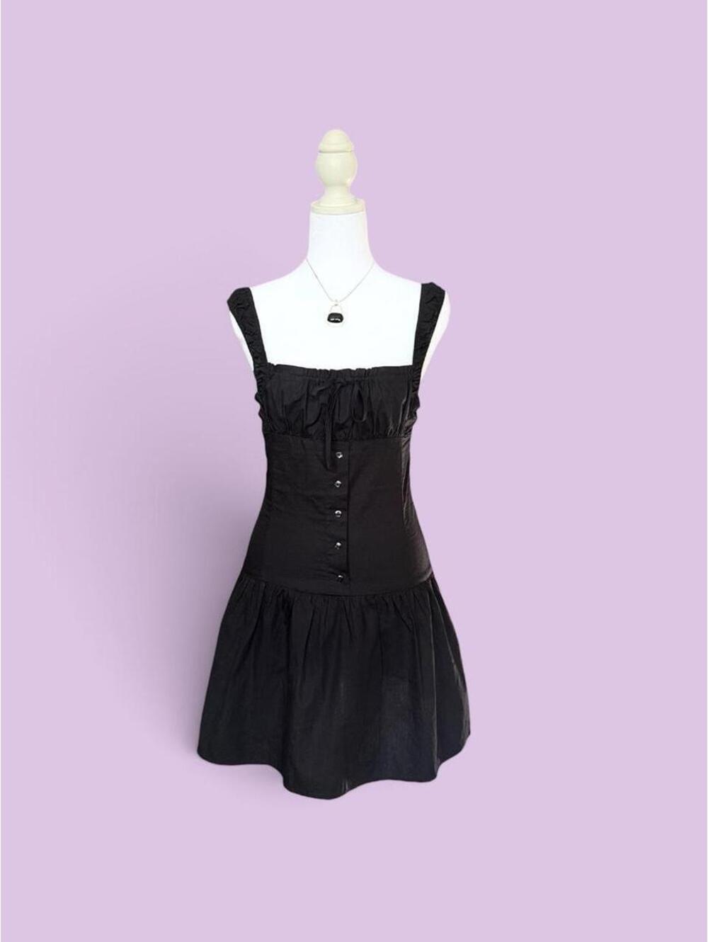 Lioness mini drop waist dress with ruffle details and button-up front.